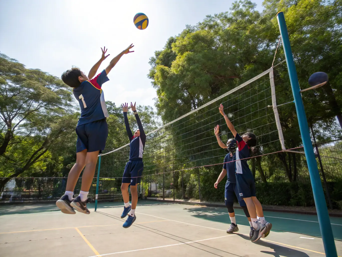 A dynamic image of students participating in a volleyball match, demonstrating agility, coordination, and strategic play.